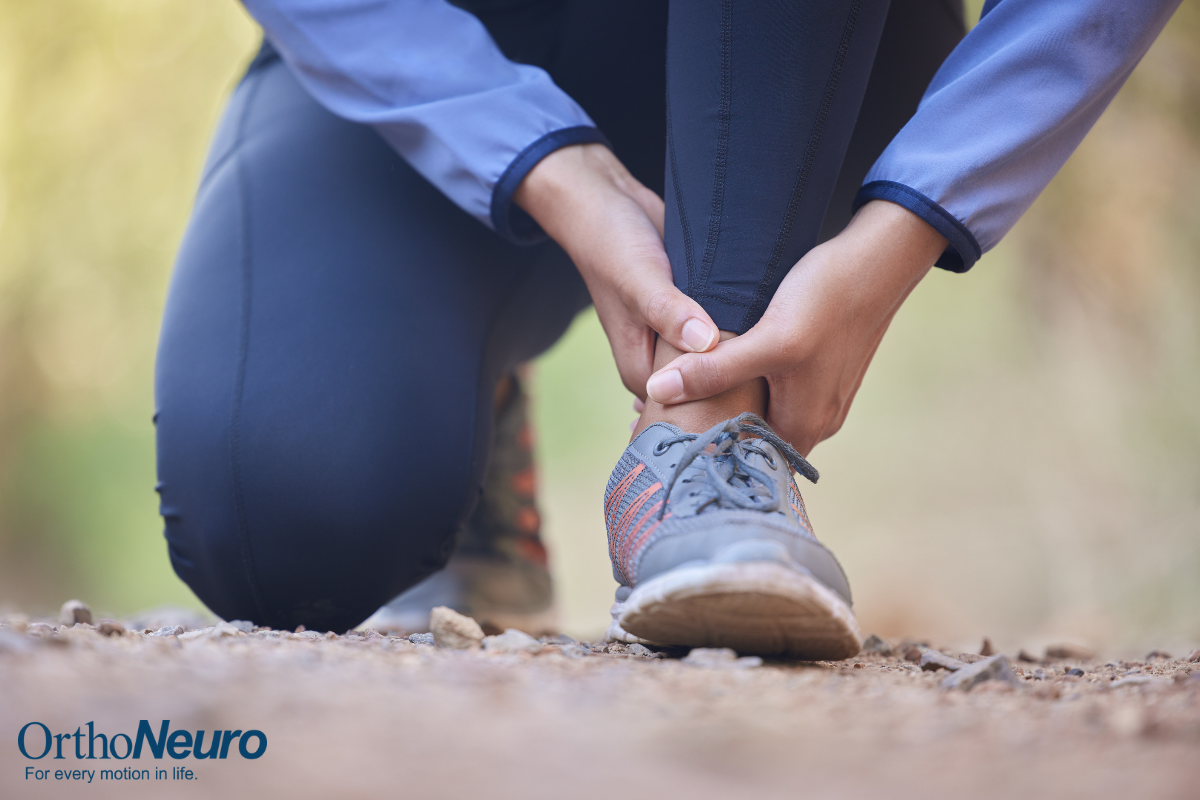 A woman holding her ankle after spraining it while hiking in Columbus, Ohio.