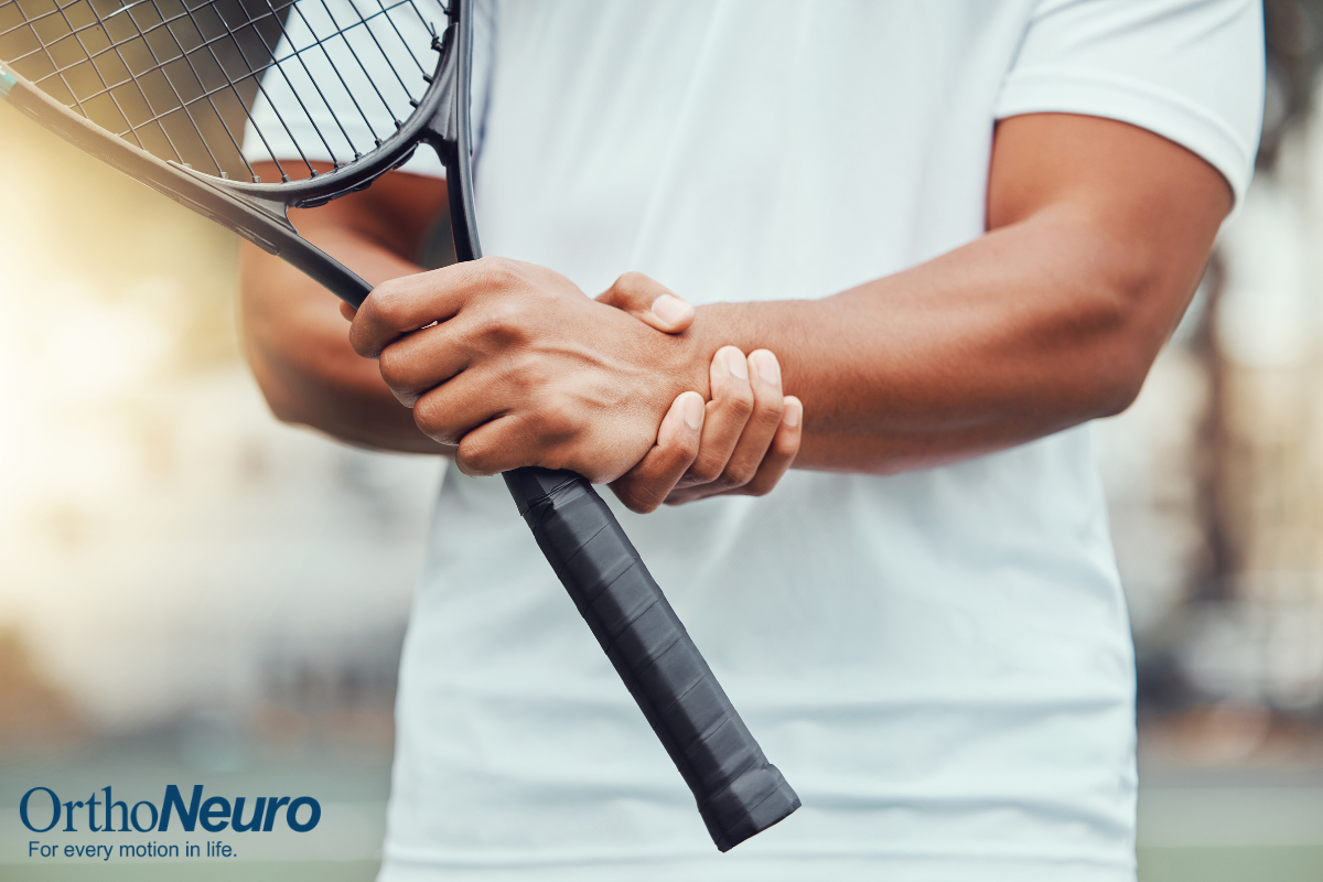 A tennis player holding his wrist in pain in Ohio.